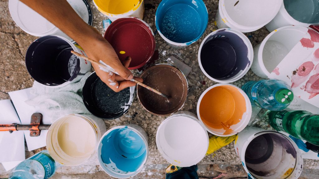 Assorted open paint buckets in many colours